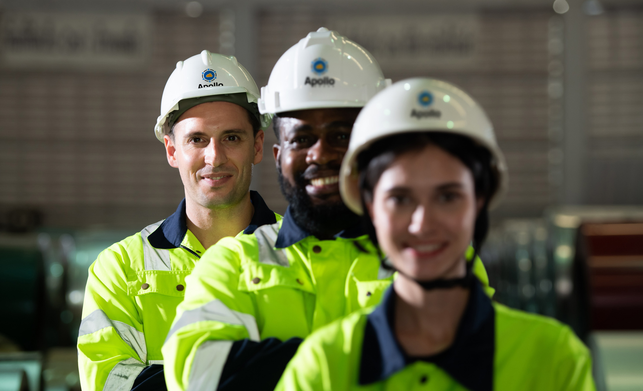 A group of female and male engineers wearing PPE at a data center construction site.