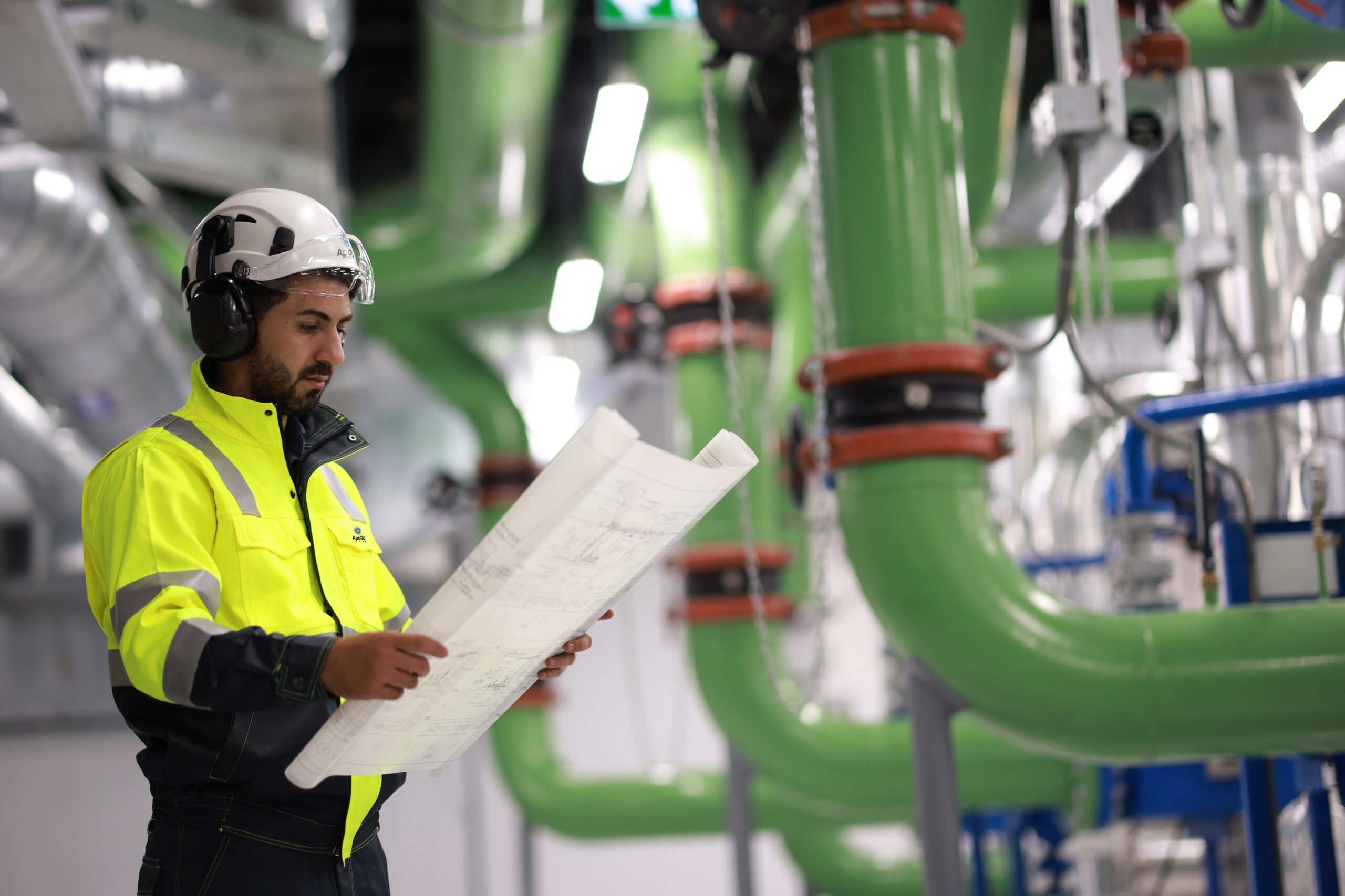 Male engineers working with project blueprints drawing in a data center.